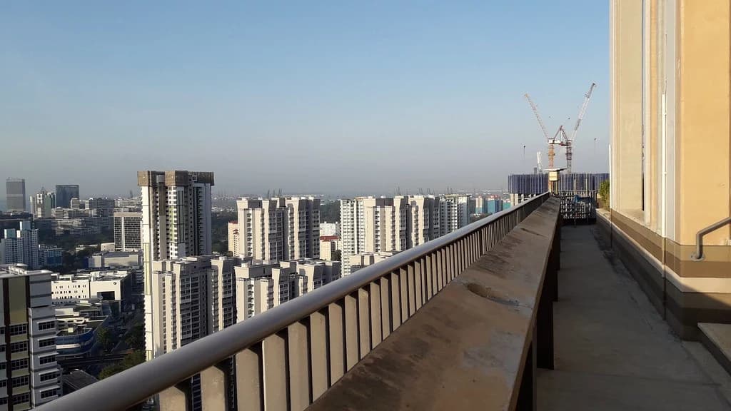 An open rooftop walkway at SkyVille @ Dawson in Singapore, with the Queenstown skyline beyond.